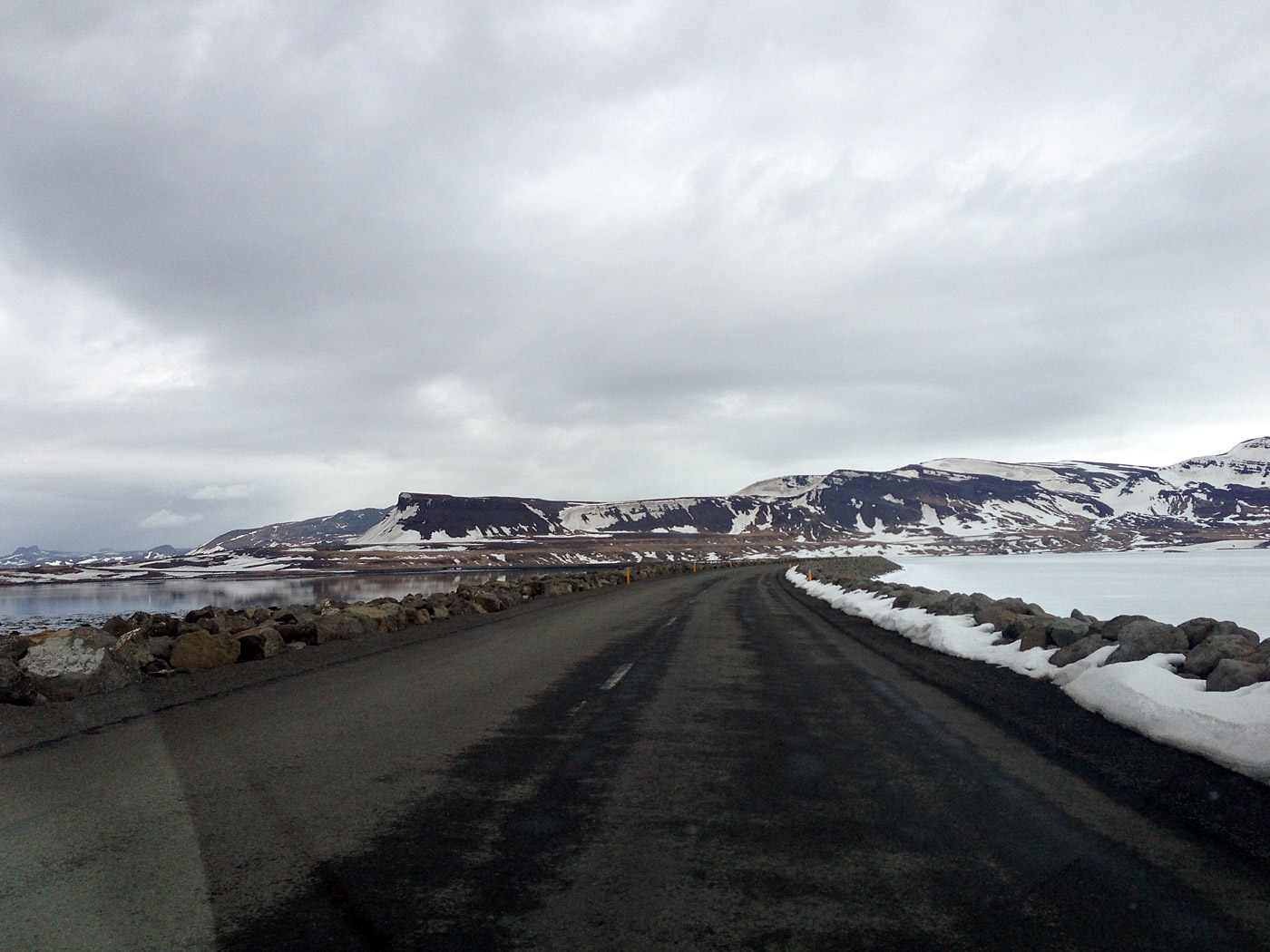 Djúpavík. Around Easter in Djúpavík. Friday. - Road 60, crossing the Gilsfjörður fjord - the sea side (left) is free of ice but the right side is covered with ice and snow. (29 March 2013)
